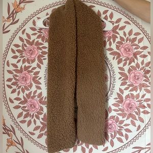 A nice fuzzy, warm, tan scarf.